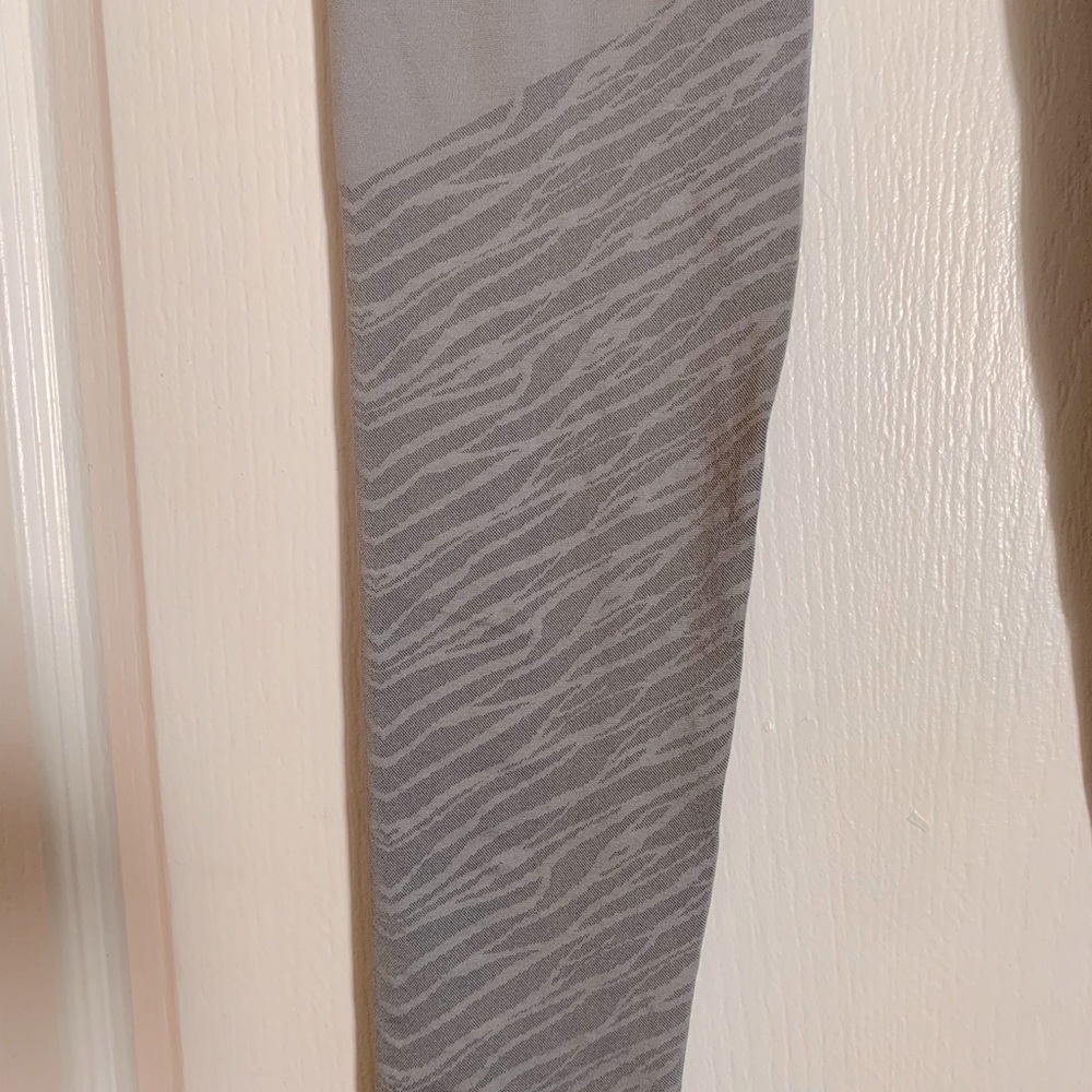 Leggings by Fabletics. Grey with zebra print around calf area